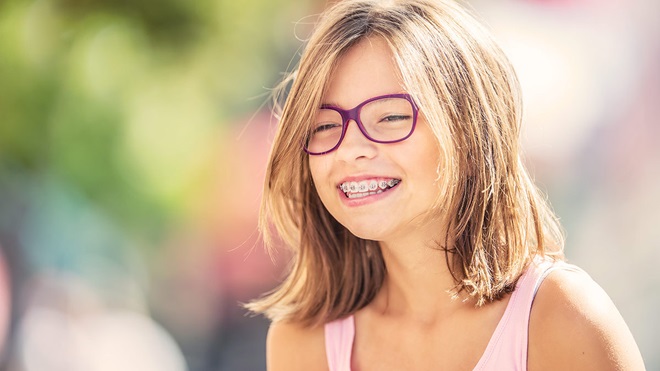 teenage girl with spectacles and orthodontic braces